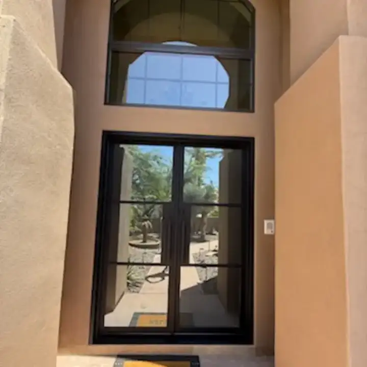 Double entry, under an arch window